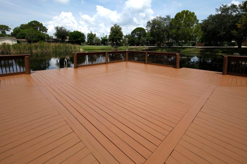 Professional estimating deck staining project costs with measurements