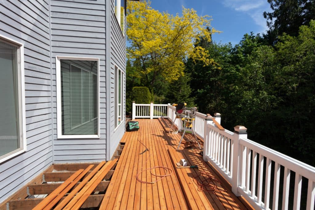 Knoxville Deck builders deck replacement contractor inspecting rotted deck framing and joists in Knoxville home